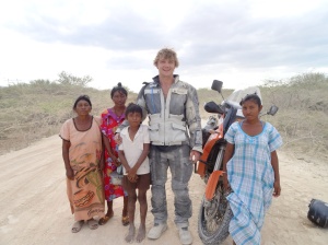 Posing with some of the curious locals after my crash in the sand. 